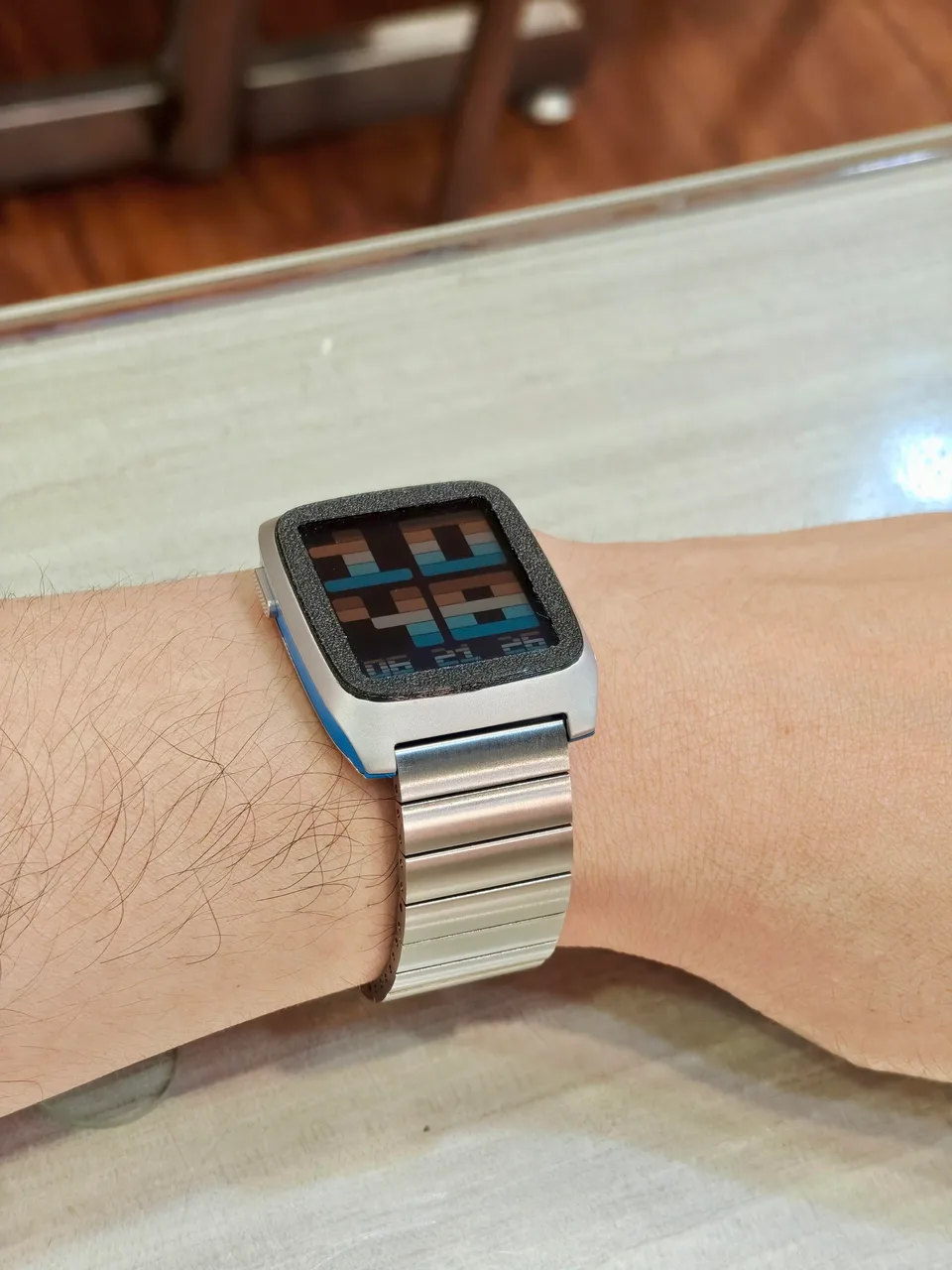 Blue Pebble Time 2 with a brushed stainless steel bracelet on the wrist