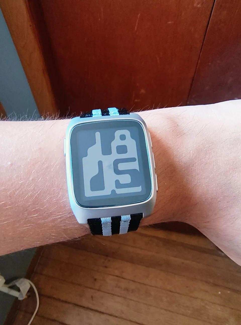 Silver Pebble Time 2 on a black and light blue striped nylon BluShark strap