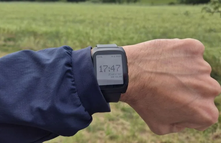 Retro Dot watchface on a Pebble worn outdoors, showing the time as a dot-matrix display