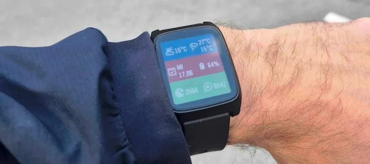 Sidecar open on a Pebble Time 2 worn on a wrist, showing a colored grid of complications